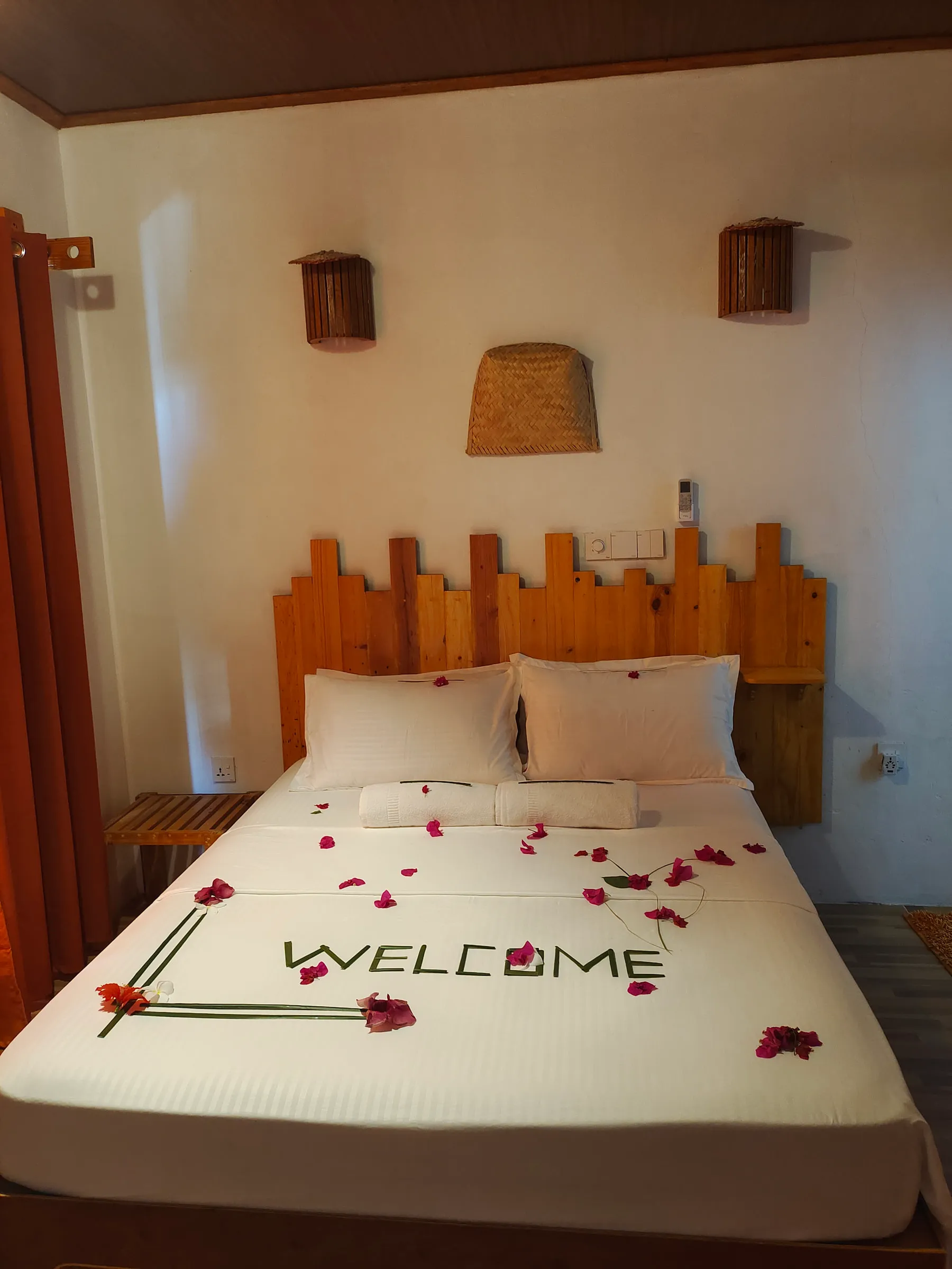 Our simple guesthouse room on Keyodhoo, with a welcome message on the bed