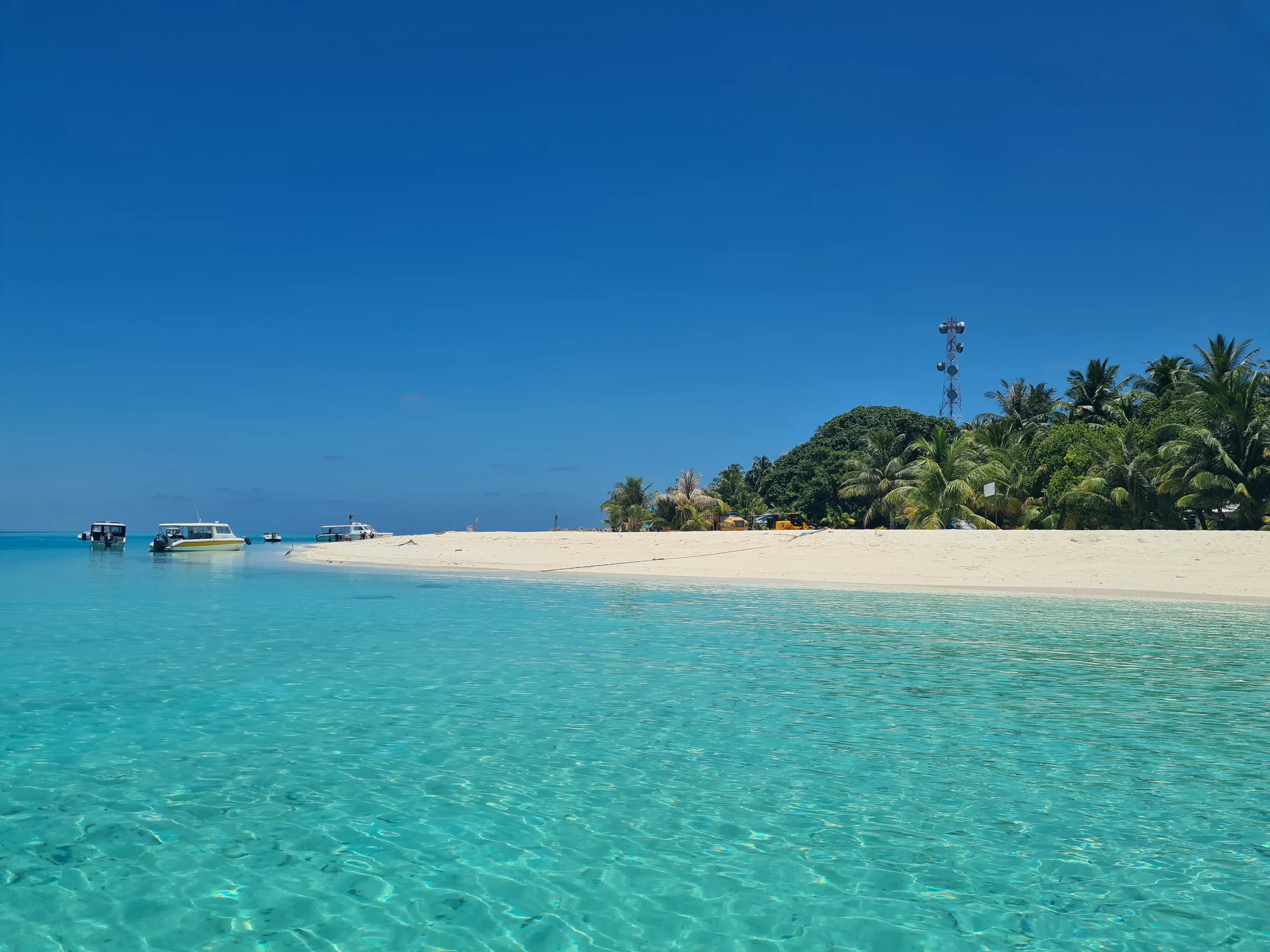 Turquoise water and a white beach on a local island in the Maldives