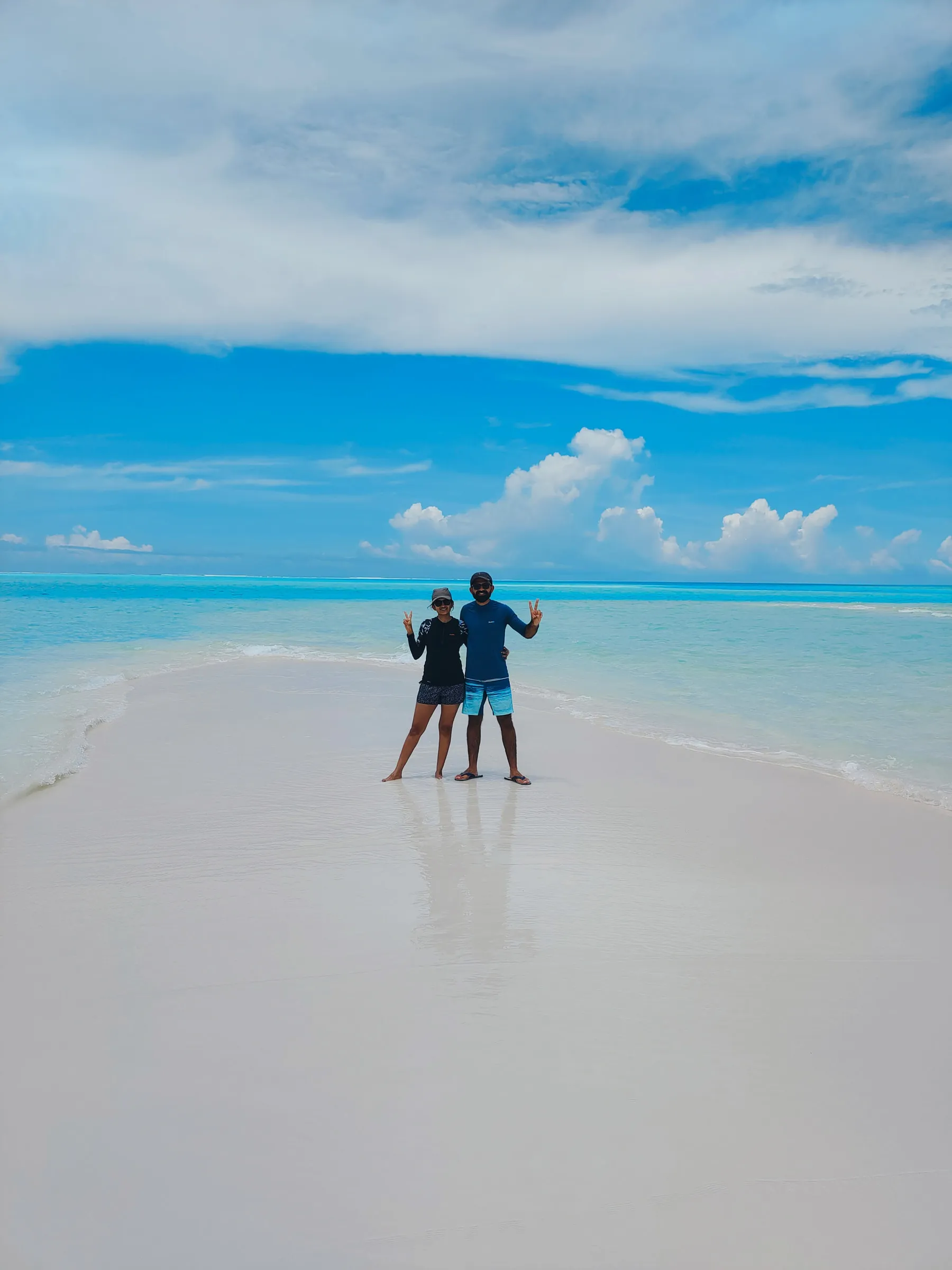 The two of us on a sandbank surrounded by clear blue water