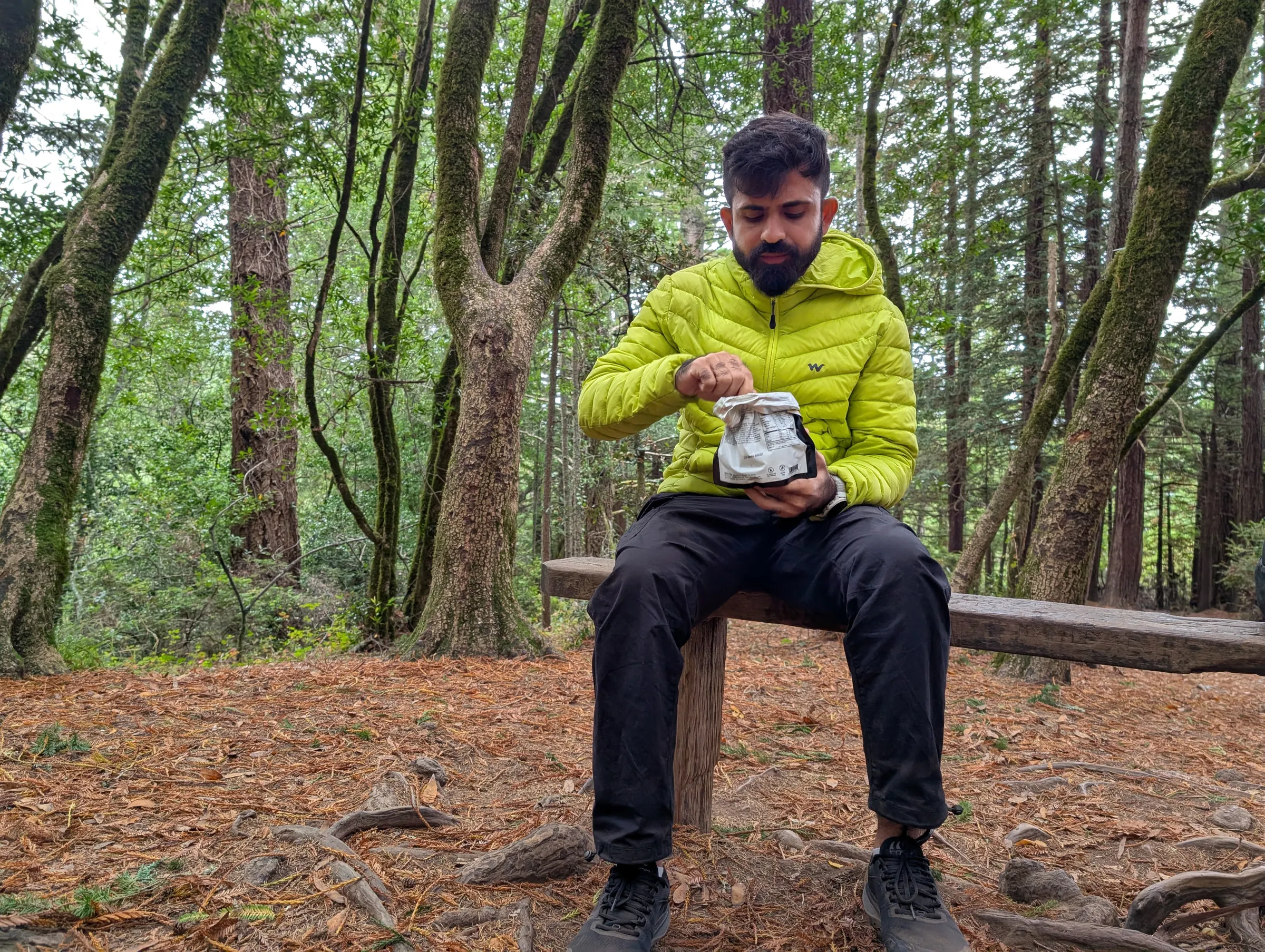 Taking a snack break on the bench at the Canopy View trail intersection